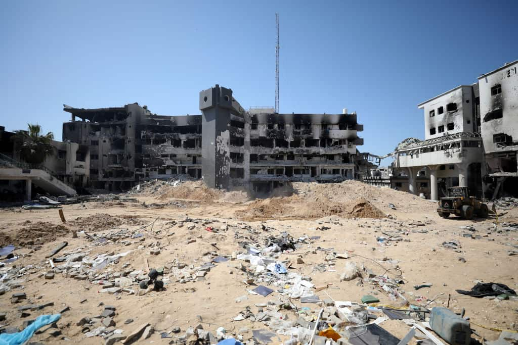 A badly damaged building with dirt in the foreground