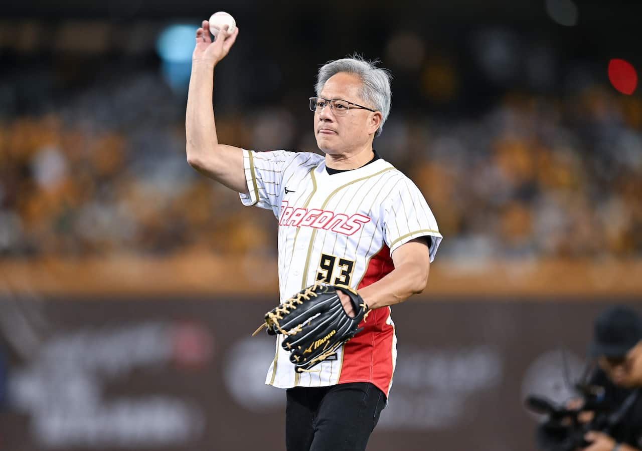 Jensen Huang throwing out the ceremonial first pitch at a baseball game.
