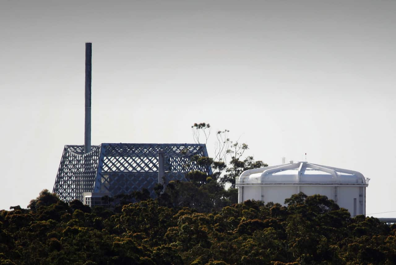 A white dome and a building with grey fencing around it.