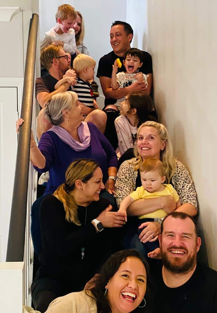 A group of people sitting on steps in a row.