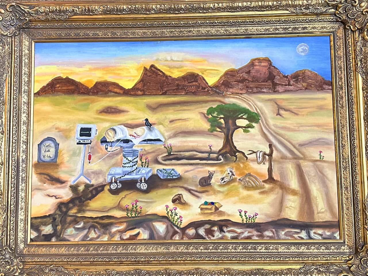 An abstratc painting of medical equipment and a horse skull in a desert.