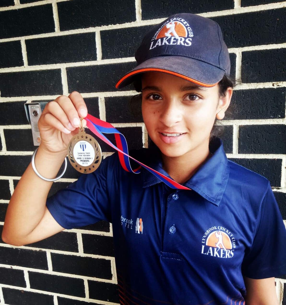 Hasrat Gill showing her premiership medal as an U13 player with Lynbrook Cricket Club