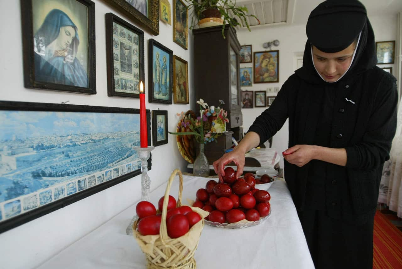 An Orthodox nun arranges fresh painted r