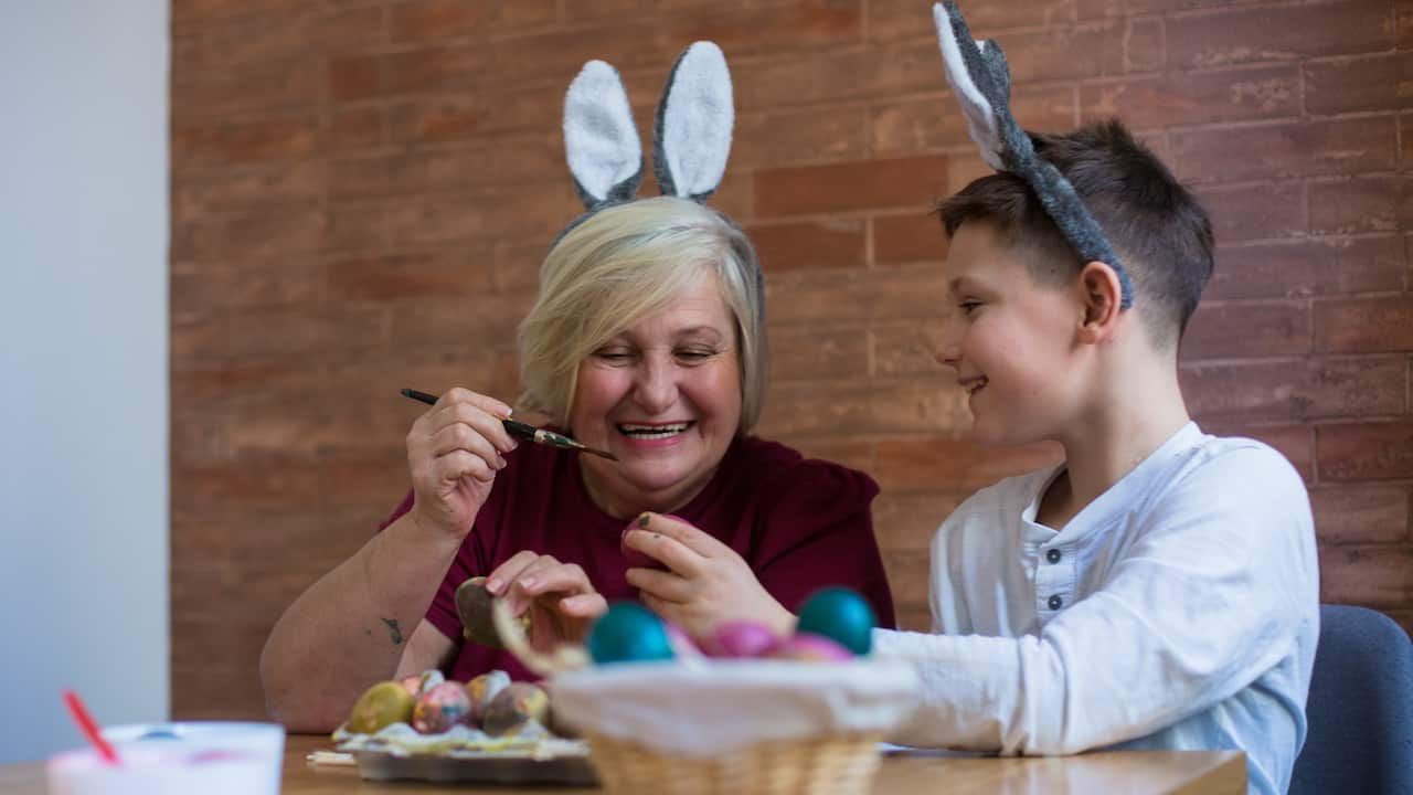 Grandma grandson painting eggs