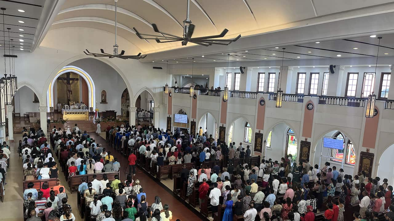 A congregation inside a Catholic church during mass