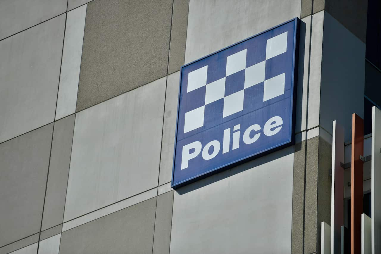 A sign on a building exterior with the word 'police'