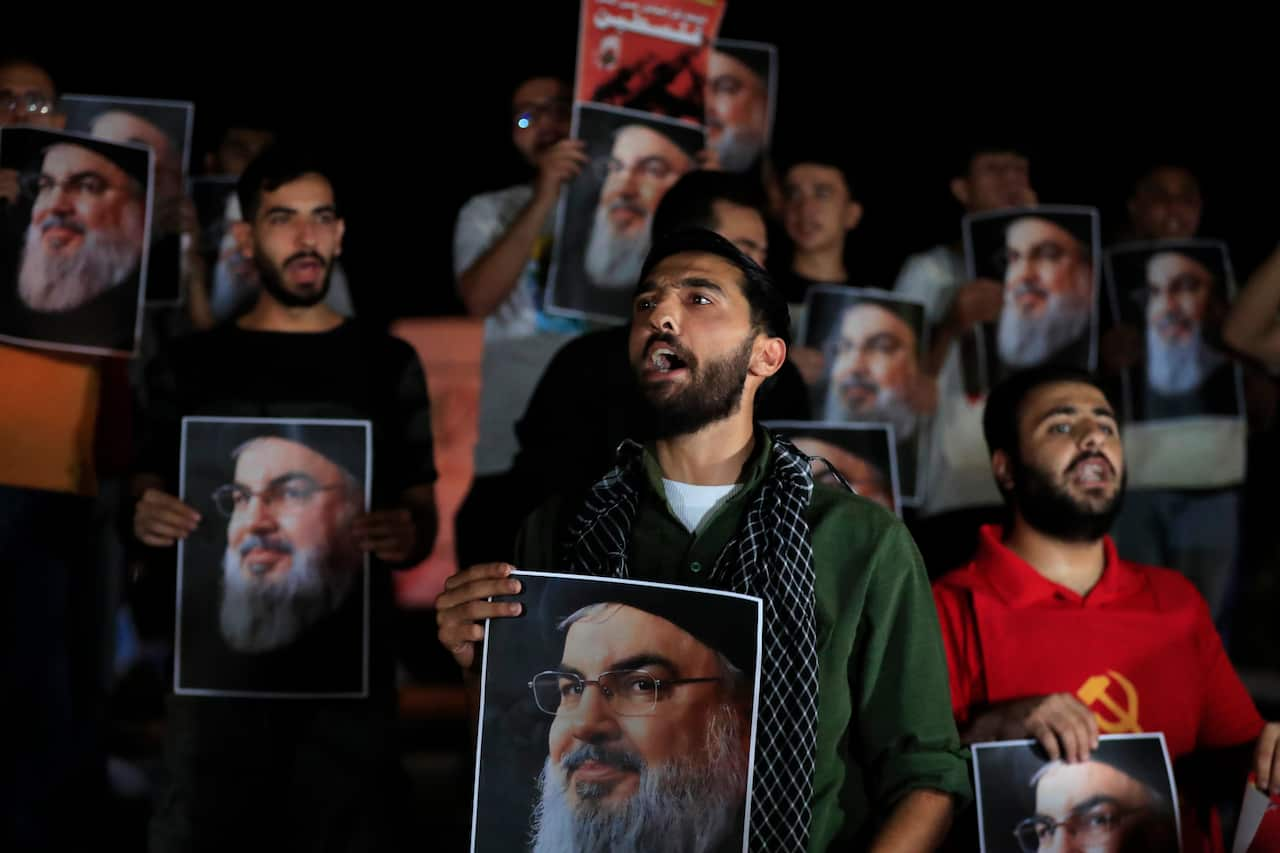 Men hold signs during a protest. 