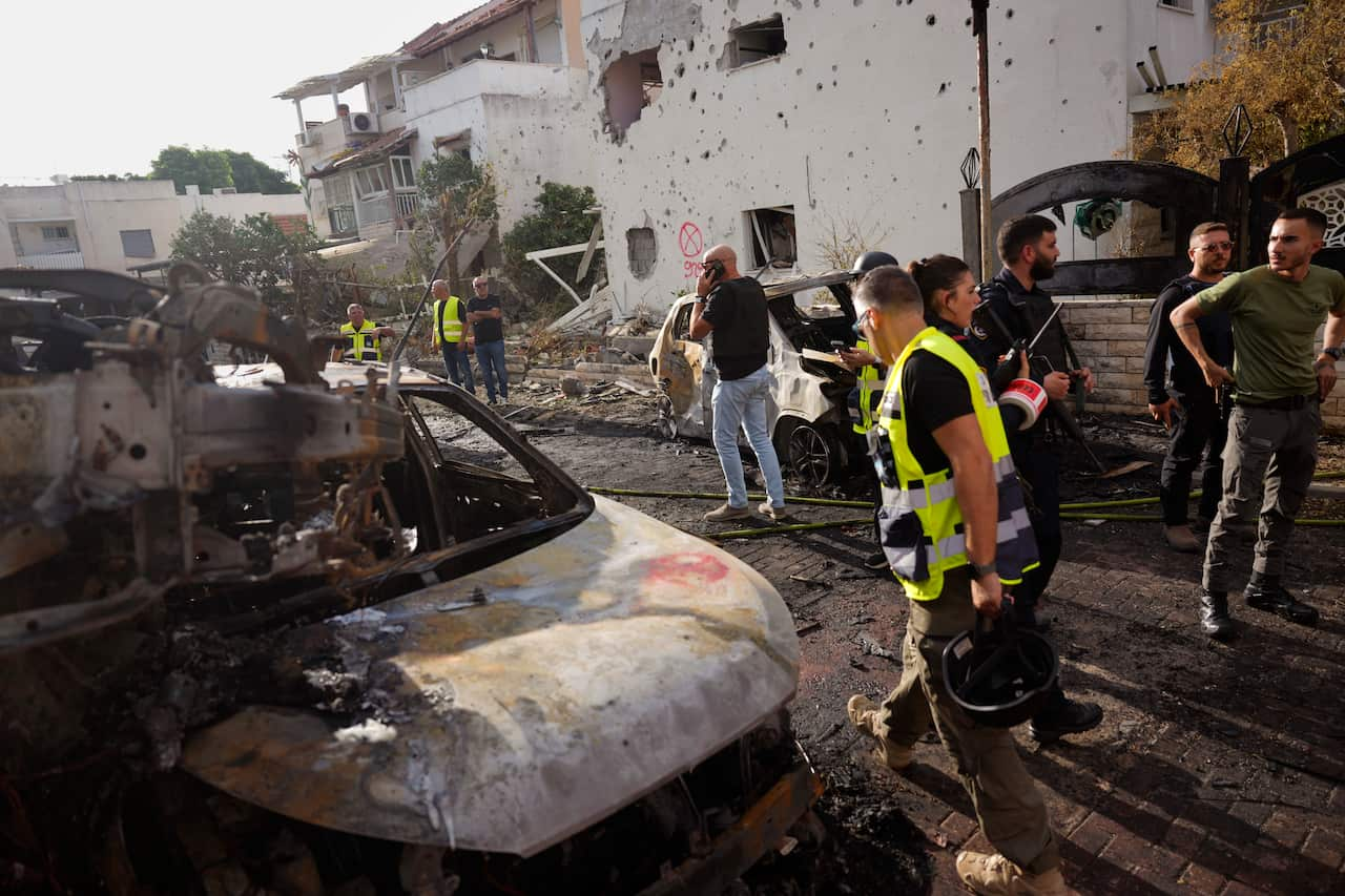 People inspect damage from an airstrike.