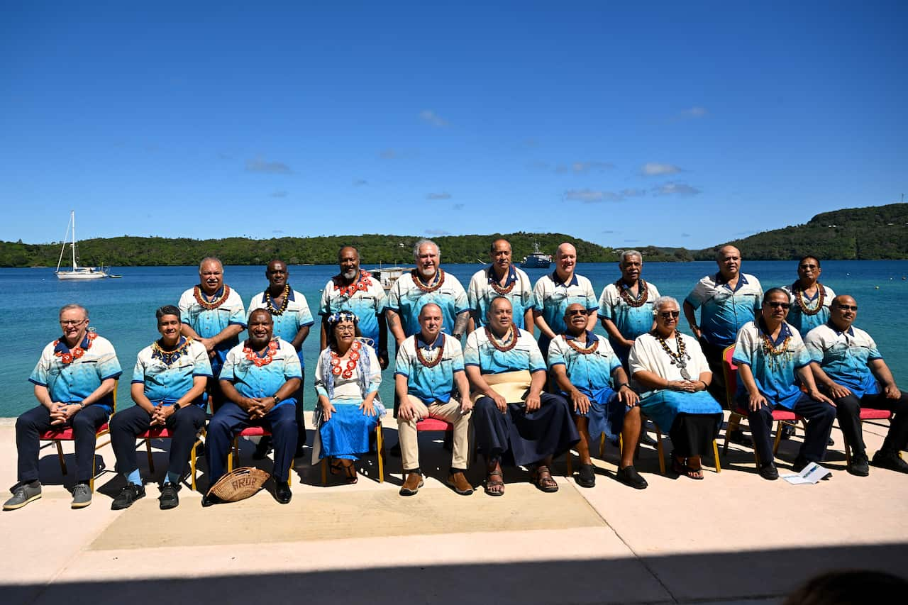 A group of leaders posing for a photo. Some are seated and some are standing.