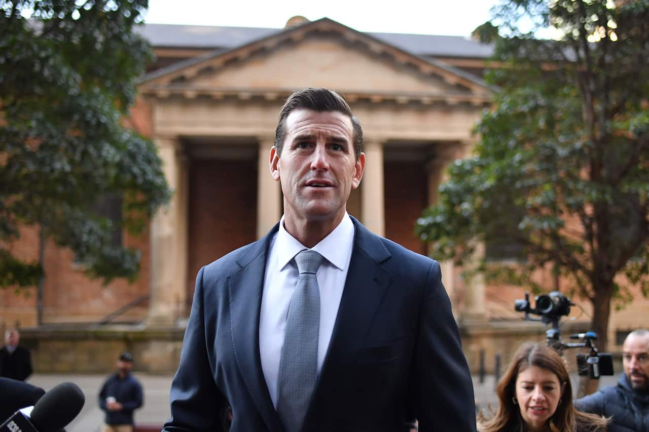 Ben Roberts-Smith wearing a suit and tie standing outside