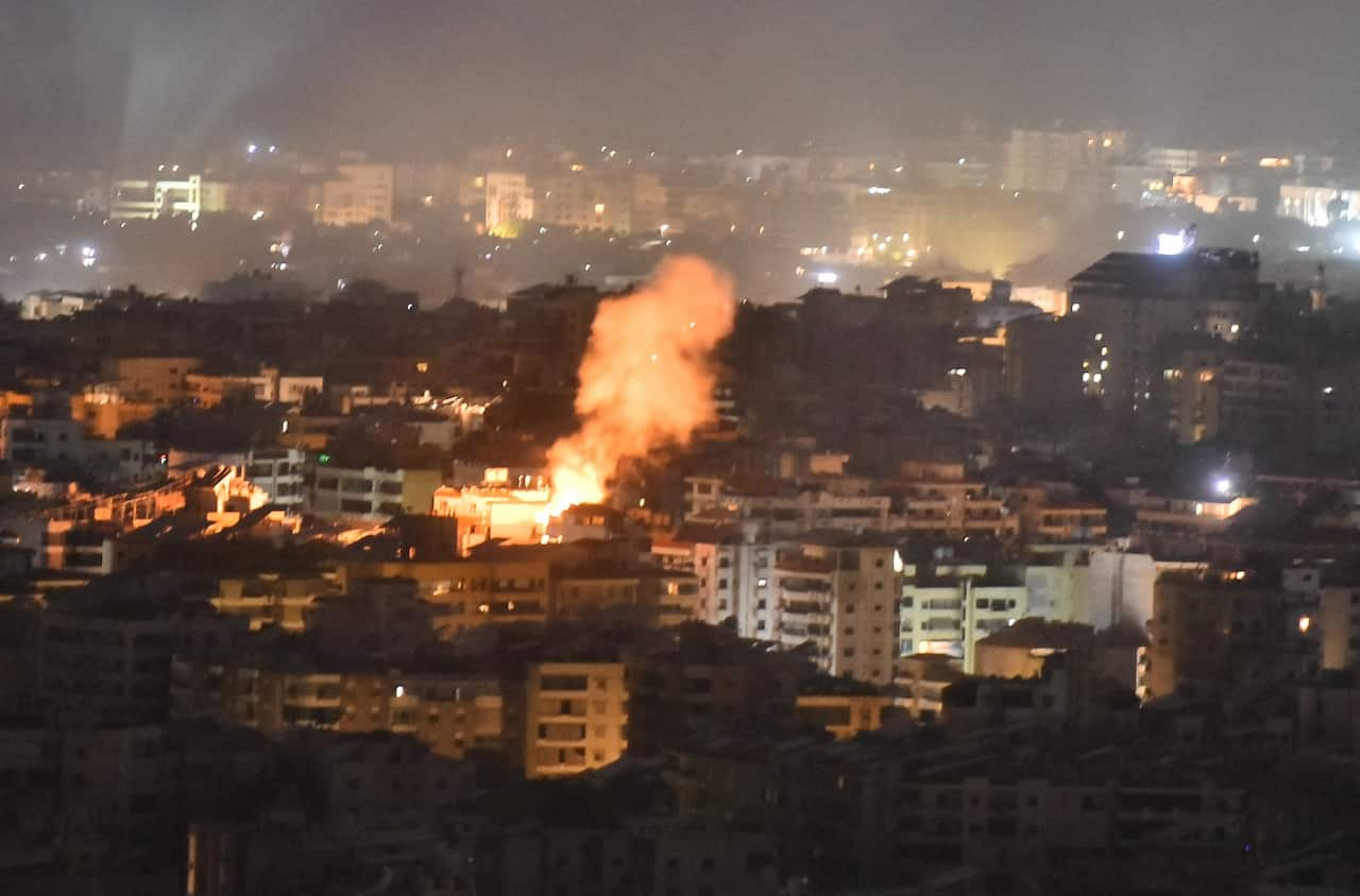 Plumes of smoke rising from a residential building.